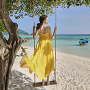 奈良云南旅游拍照三亚沙滩裙女2024海边度假长裙吊带连衣裙夏黄色