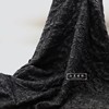 黑色岩石泡泡感立体浮雕提花布料 设计师半裙伞裙装饰画时装面料